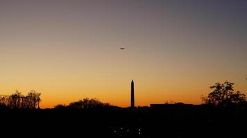 The beautiful sunset city view with the silhouette of the monument tower in Washington DC photo
