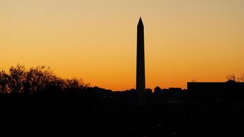 The beautiful sunset city view with the silhouette of the monument tower in Washington DC photo