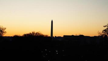 The beautiful sunset city view with the silhouette of the monument tower in Washington DC photo