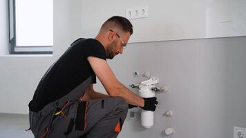 Plumber installs or change water osmosis filter video