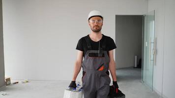 Foreman in uniform walking with tools on construction site video