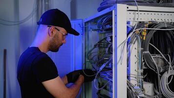 Network and data center with it support engineer working in a dark server room video