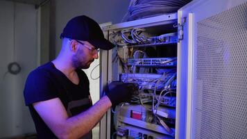 Network and data center with it support engineer working in a dark server room video