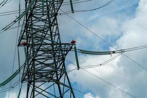 High voltage towers with sky background. Power line support with wires for electricity transmission. High voltage grid tower with wire cable at distribution station. Energy industry, energy saving photo