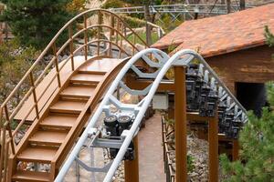 Rollercoaster Track Stairs Wooden Structure - A close-up of a wooden rollercoaster track with stairs and a wooden structure in the background. photo