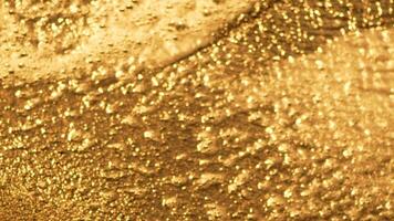 Water Sunlight Reflections Abstract Blurred Background. Abstract close-up of shimmering water with golden light reflecting off the surface. The water is out of focus, creating a bokeh effect. photo