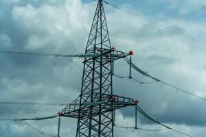 High voltage towers with sky background. Power line support with wires for electricity transmission. High voltage grid tower with wire cable at distribution station. Energy industry, energy saving photo
