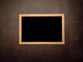 Top view of empty blackboard with a wooden frame over a vintage background photo
