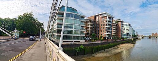 Wide Angle Panoramic Central Chelsea London city on river Thames Albert Bridge Road England United Kingdom. Low Angle High Resolution Image Was Captured on June 3rd, 2024 photo