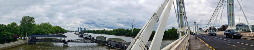Wide Angle Panoramic Central Chelsea London city on river Thames Albert Bridge Road England United Kingdom. Low Angle High Resolution Image Was Captured on June 3rd, 2024 photo