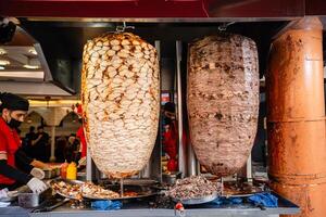 Kuala Lumpur, MALAYSIA - January 29, 2024. chef preparing and making Traditional Turkish Doner Kebab meat. It also knowns as Shawarma.It is a one of the famous street food in Bukit Bintang. photo