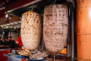 Kuala Lumpur, MALAYSIA - January 29, 2024. chef preparing and making Traditional Turkish Doner Kebab meat. It also knowns as Shawarma.It is a one of the famous street food in Bukit Bintang. photo