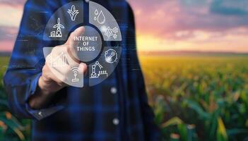 Man holding a virtual button with icons of agriculture and technology photo