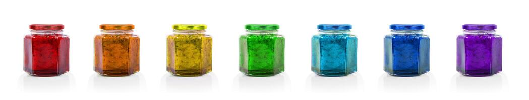 Banner with colorful raw of seven rainbow colored hexagonal jam jars with gold lids, ideal for branding, Packaging design, minimalist product photography. Isolated on white background. photo