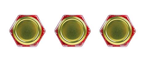 Three isolated hexagonal jars with golden cap containing red contents, perfect for product design, branding, or minimalist food packaging visuals. Top view. Copy space photo