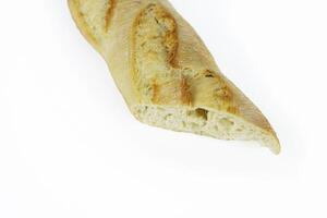 Closeup of a sliced French baguette with a crispy crust and airy texture isolated on a white background. With clipping path. Copy space photo