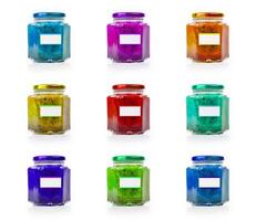 Grid of 9 colorful glass jars with blank labels, perfect for showcasing product variety and creative branding. Organized display of nine rainbow colored jars. Isolated on white background photo