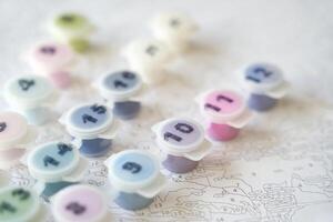 Creative diy paint-by-number kit with paint pots on abstract background for artistic hobbies and crafts. photo