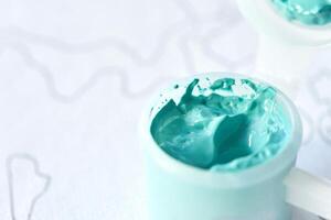 Close-up of turquoise paint texture in a container for artistic projects and creative inspiration. photo