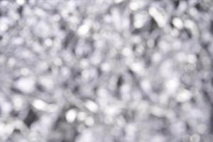 Abstract silver bokeh background with blurred light and soft focus. photo