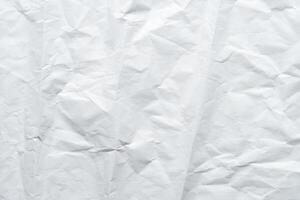 Crumpled white paper texture ideal for backgrounds and artistic projects. photo