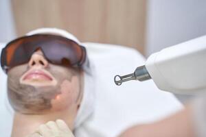 Advanced laser skin treatment in professional clinic for rejuvenation and clear complexion with safety precautions. photo