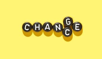 Inspirational concept of change word with letter tiles on vibrant yellow background for transformation and adaptation themes. photo