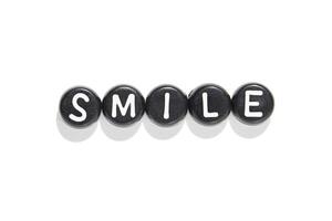 Smile in black and white. letter beads on white background capture simplicity and positivity in minimalist design photo