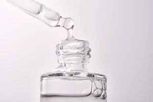 Close-up of a cosmetic bottle with a pipette showing the texture of the serum. photo