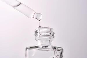 Close-up of a cosmetic bottle with a pipette showing the texture of the serum. photo