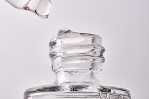 Close-up of a cosmetic bottle with a pipette showing the texture of the serum. photo