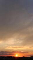 A sunset over a city with a plane flying over it photo