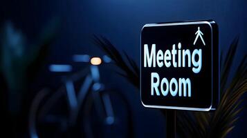 Meeting Room sign on office glass wall with empty collaboration workspace, large table, and armchairs in background. photo