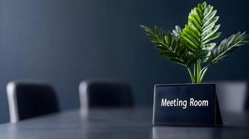 Meeting Room sign on office glass wall with empty collaboration workspace, large table, and armchairs in background. photo