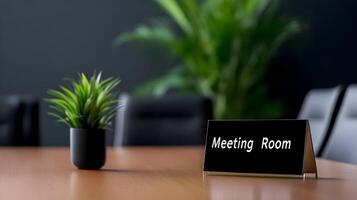 Meeting Room sign on office glass wall with empty collaboration workspace, large table, and armchairs in background. photo