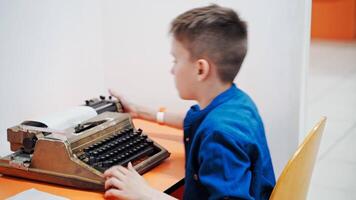Little boy with the old typewriter, close up video