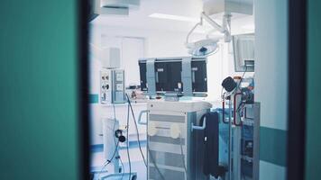 Back view of modern techniques in the operating room through the window of the door. Medical equipment in operating room in a private clinic. video
