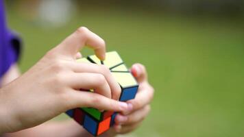 Boy practices with difficult Rubik's Cube. Smart teenager solving puzzle game with new Rubik's cube. Concept of problem solving, solution, focus and goal. video