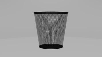 A black trash can with mesh netting on it photo