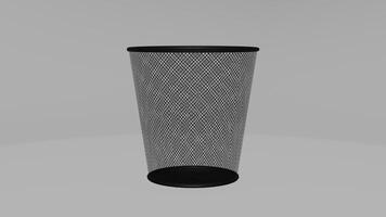 A black trash can with mesh netting on it photo