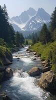 Mountain Stream Flowing Through a Valley with Snow-Capped Peaks in the Background photo