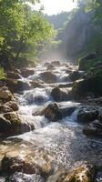 A Cascading Stream Flows Through a Rocky Gorge Bathed in Sunlight photo