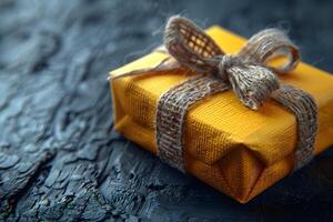 Rustic Gift Box Wrapped in Burlap Ribbon on Textured Dark Background for Special Occasions photo