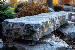 Natural Stone Bench in Autumn Garden for Tranquil Outdoor Spaces photo