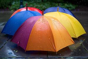 Colorful Umbrellas in the Rain on a Wet Pavement photo