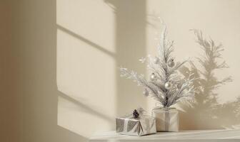 A white wall with a Christmas tree and two boxes on a table photo
