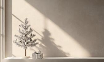 A silver christmas tree with a silver box on a shelf photo