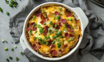 A white bowl of food with bacon and onions photo