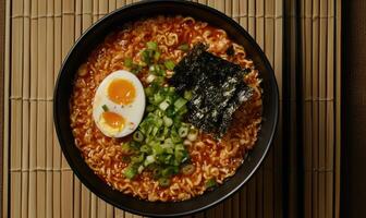 A bowl of ramen with egg and green onions photo