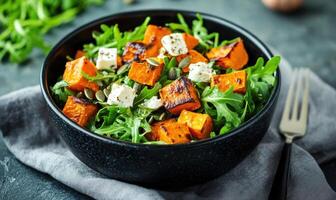 A bowl of food with a fork and knife on a table photo